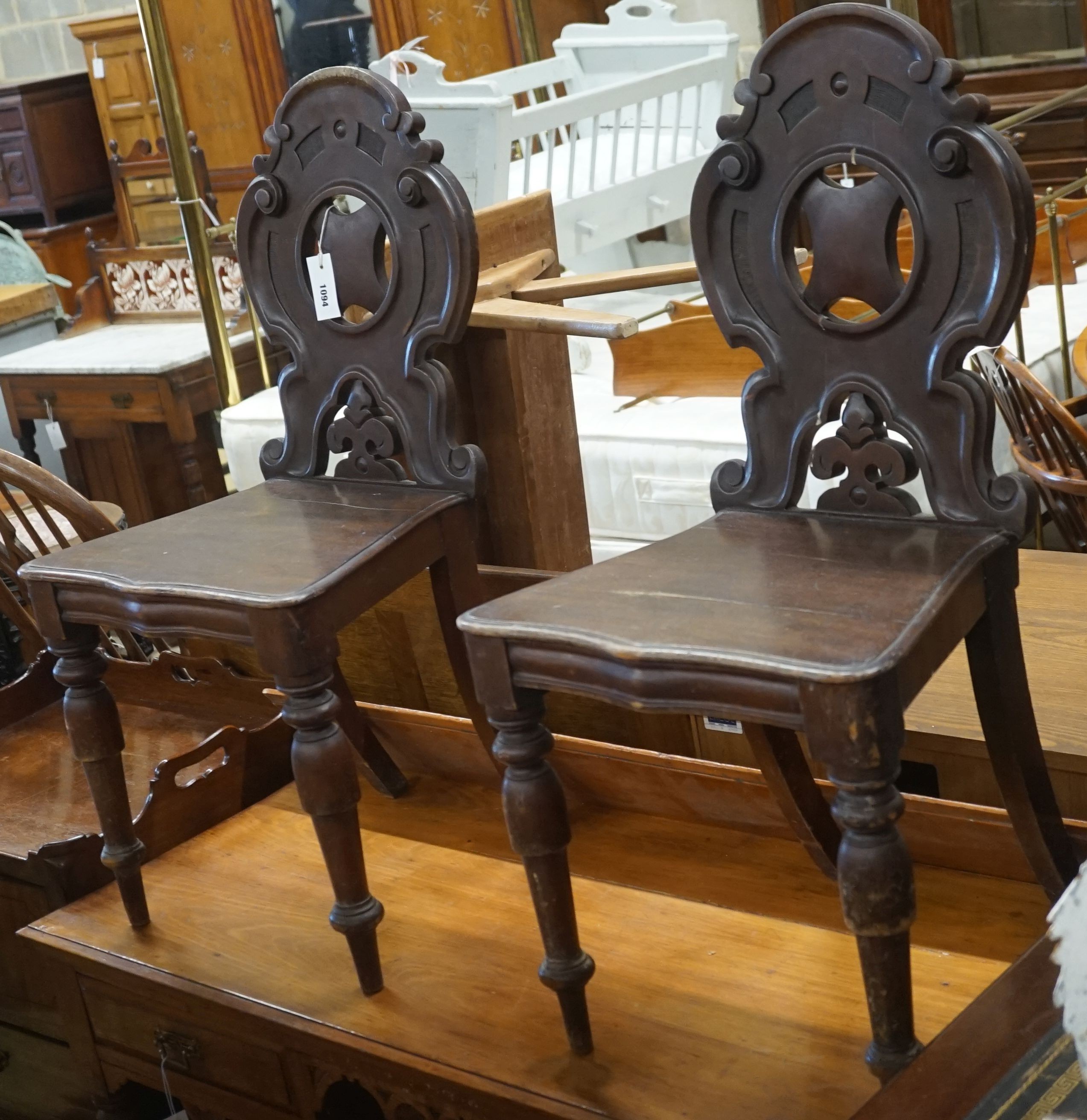 A pair of Victorian mahogany hall chairs